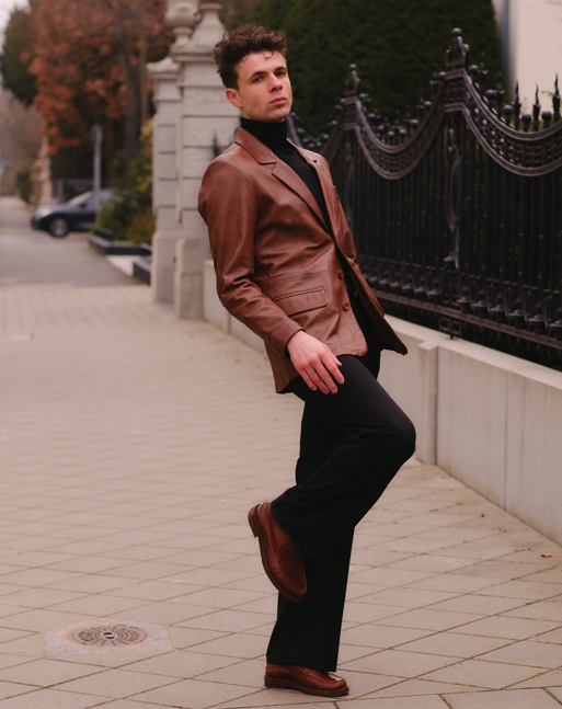 Model walking, wearing a mens brown leather blazer from Cycas d'Or