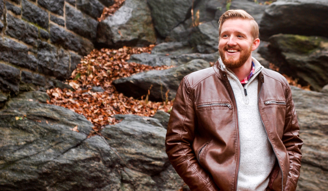 Smiling man in nature wearing a dark brown Cycas d'Or leather jacket 