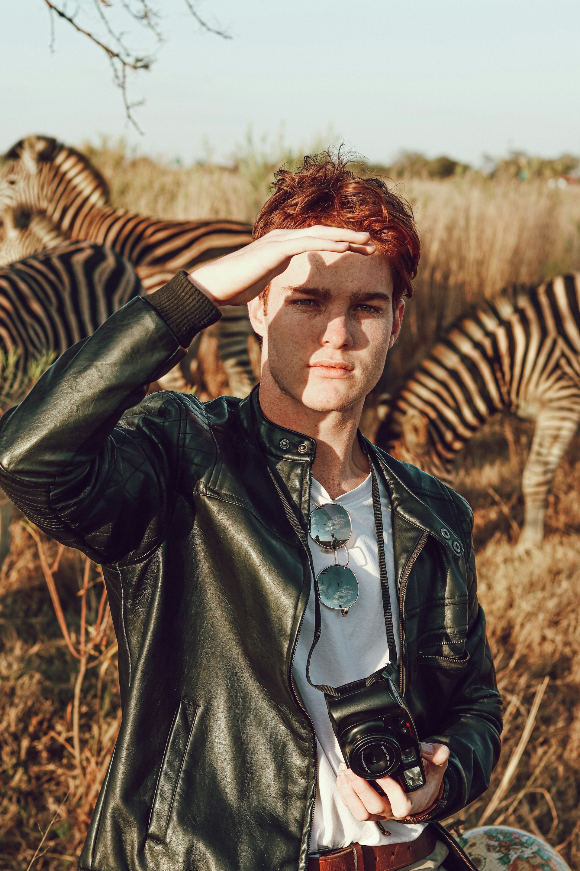 Photographer wearing a Cycas d'Or Leather jacket in the nature, close to zebras